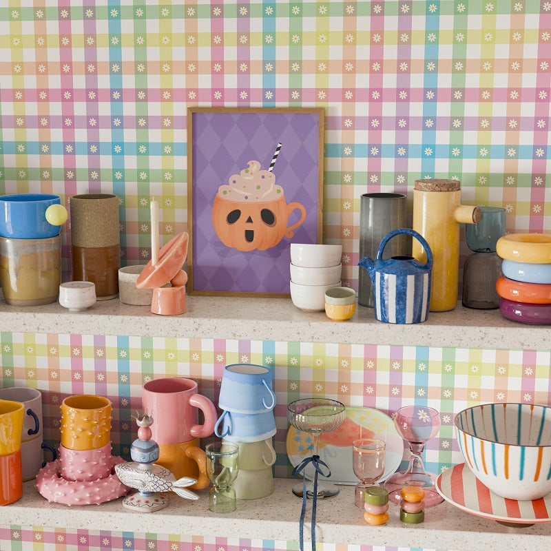Colorful kitchenware on a shelf against a pastel checkered wall