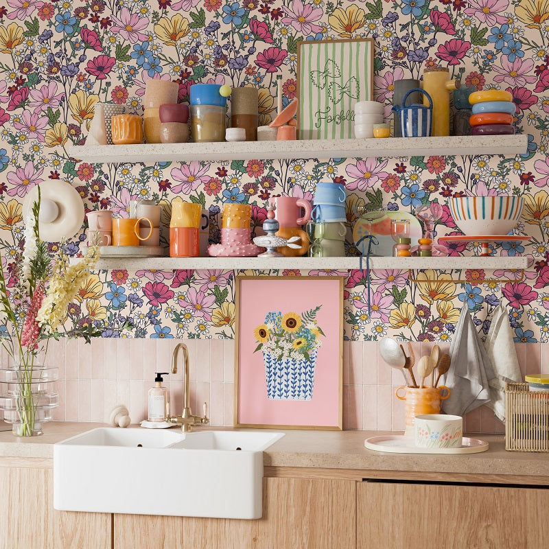 a kitchen with a colorful floral wallpaper, a white sink, and shelves filled with various kitchen items such as cups, bowls, and utensils.