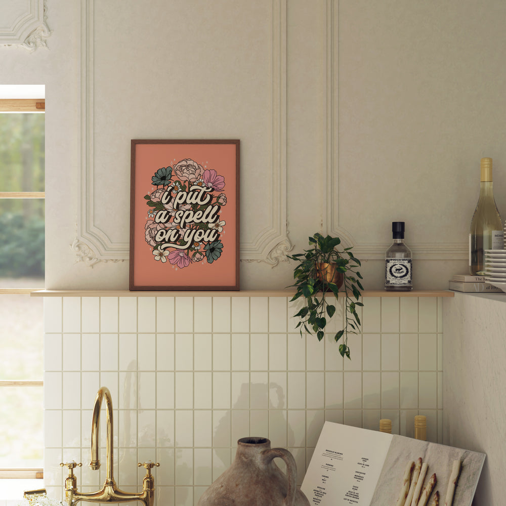 Decorative shelf with a framed quote, plant, and bottles against a tiled wall.