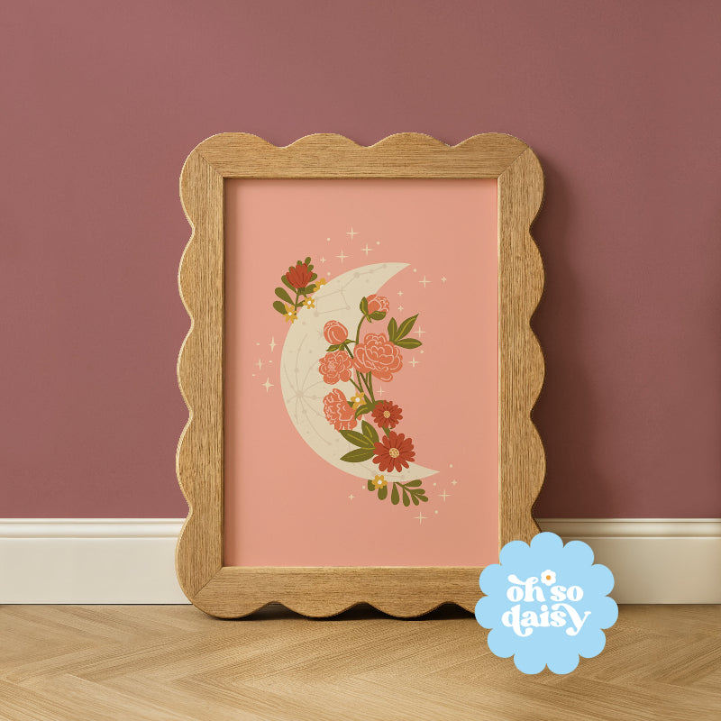 Framed artwork with floral design on a pink background, featuring 'oh so daisy' logo.