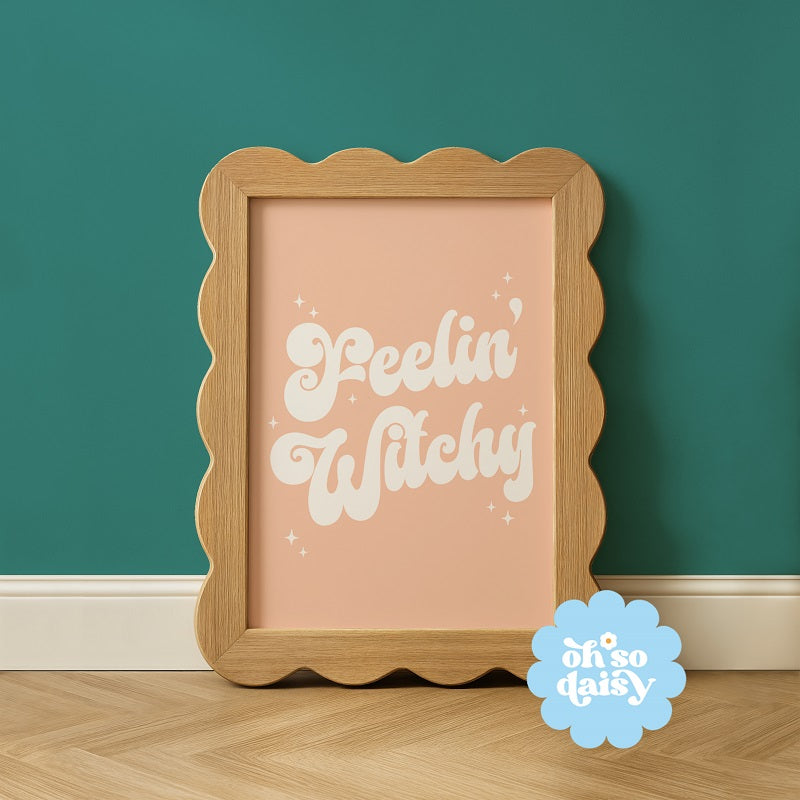 Wooden framed picture with 'Peelin' Witchy' text on a teal wall, featuring 'oh so daisy' logo.