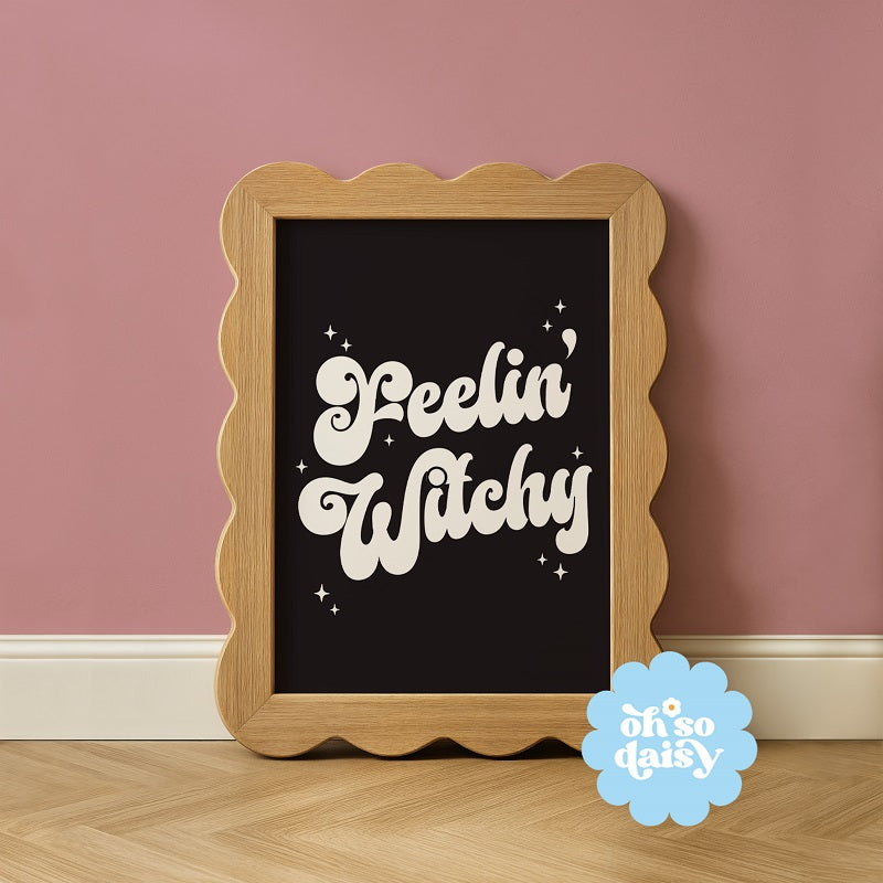 Wooden-framed sign with 'Peelin' Witchy' text on a pink wall, featuring 'oh so daisy' logo.