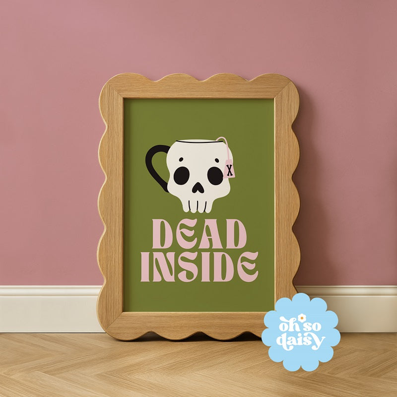 Framed artwork with skull design and 'Dead Inside' text on a green background, against a pink wall.
