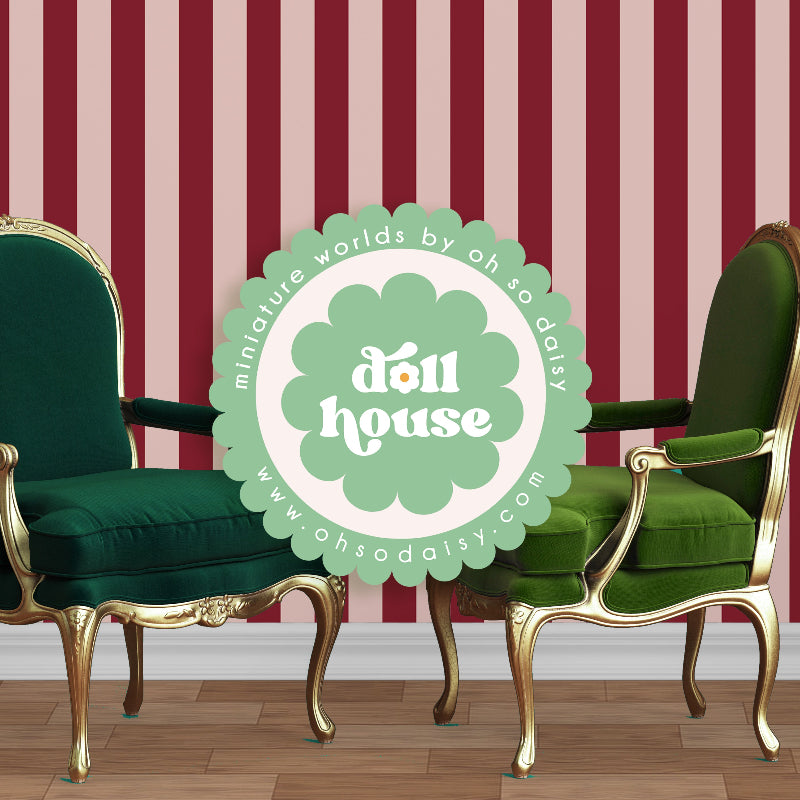 Two green chairs with gold legs in front of a red and white striped wall with 'doll house' logo.