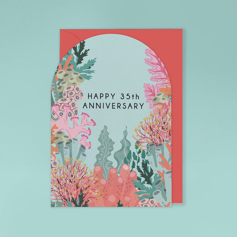 A coral-themed 35th anniversary greeting card with a matching envelope, featuring an underwater coral reef illustration and the text 'HAPPY 35th ANNIVERSARY' on a light aqua background.
