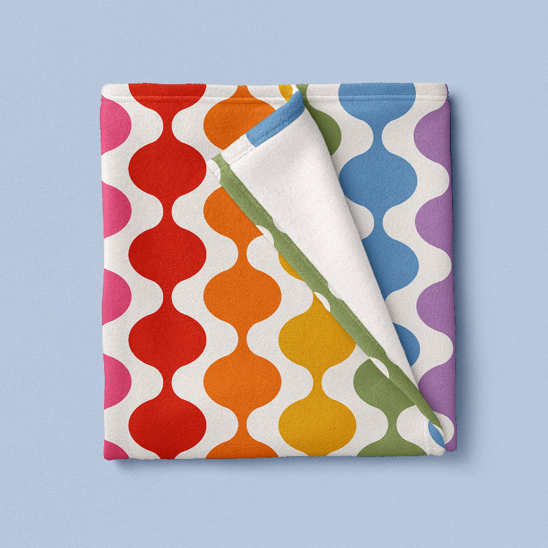 Colorful patterned fabric with wavy design on a light blue background