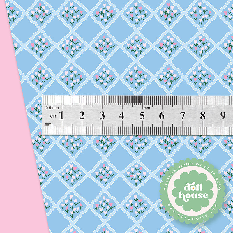 Fabric with floral pattern and ruler for scale, featuring 'doll house' brand.