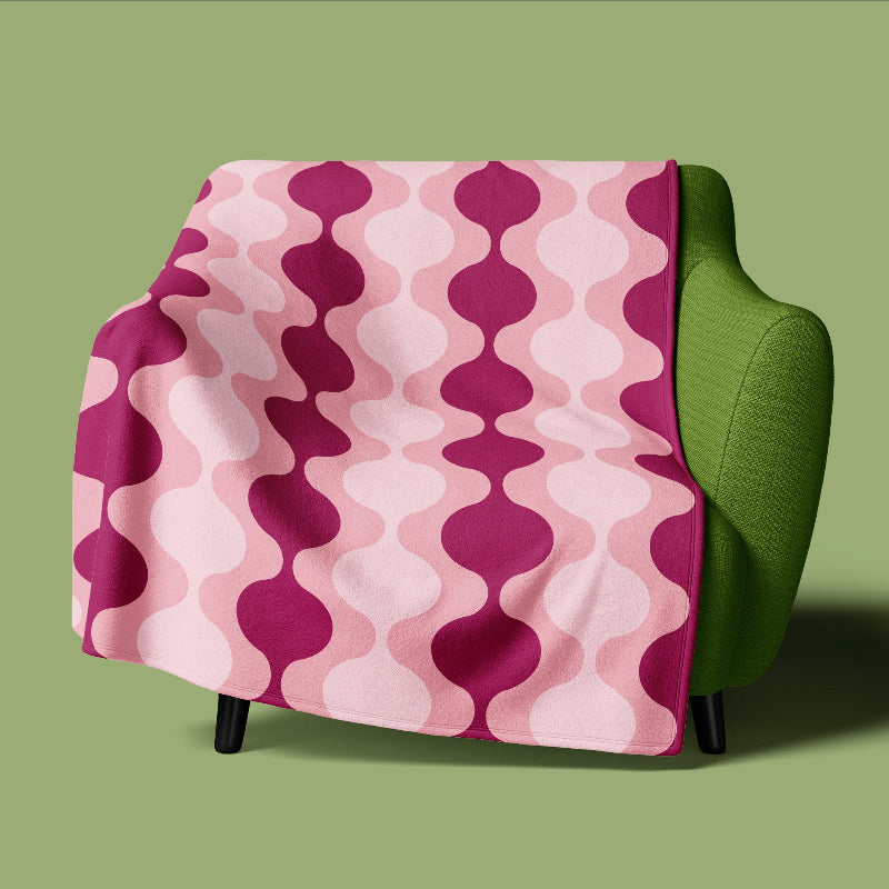 Green chair with a pink and purple patterned cover on a green background
