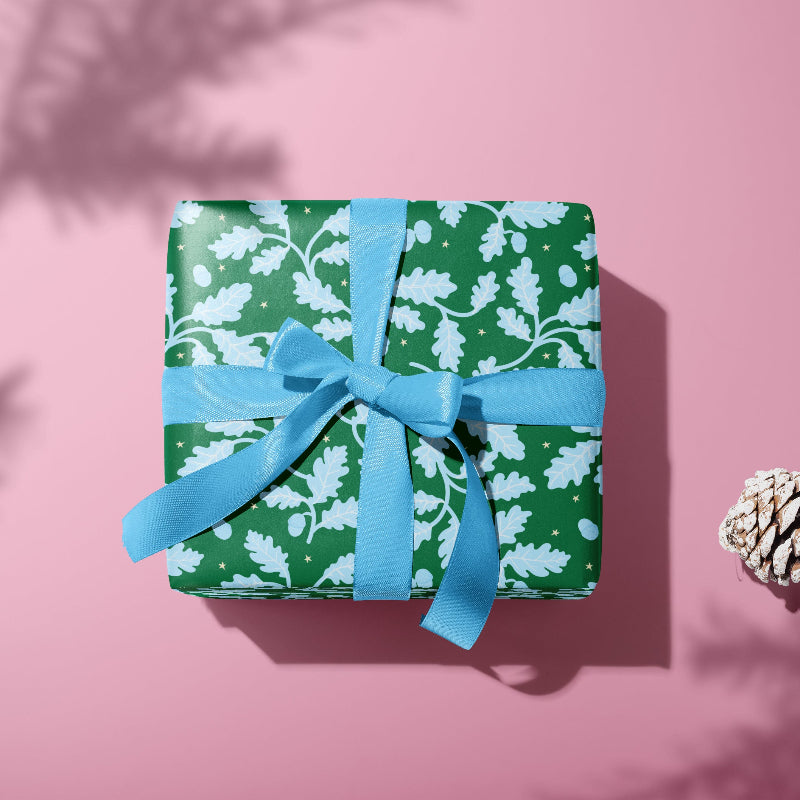 Say hello to Acorn Oak gift wrap. Featuring bright blue oak leaves and acorns scattered across a cheerful green background, sprinkled with twinkling hand-drawn stars, this gift wrap is full of festive charm and whimsy. Perfect for mixing and matching with our floral Hollyhock prints or wavy candy cane stripes, it’s a joyful way to make your gifts feel extra special this Christmas.