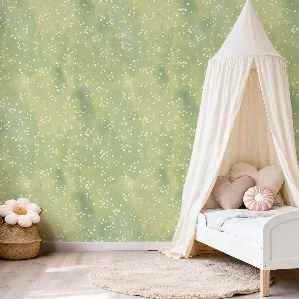 Meadow Mist green ditsy floral wallpaper in a girls nursery bedroom creating a soft country style interior with subtle daisy pattern